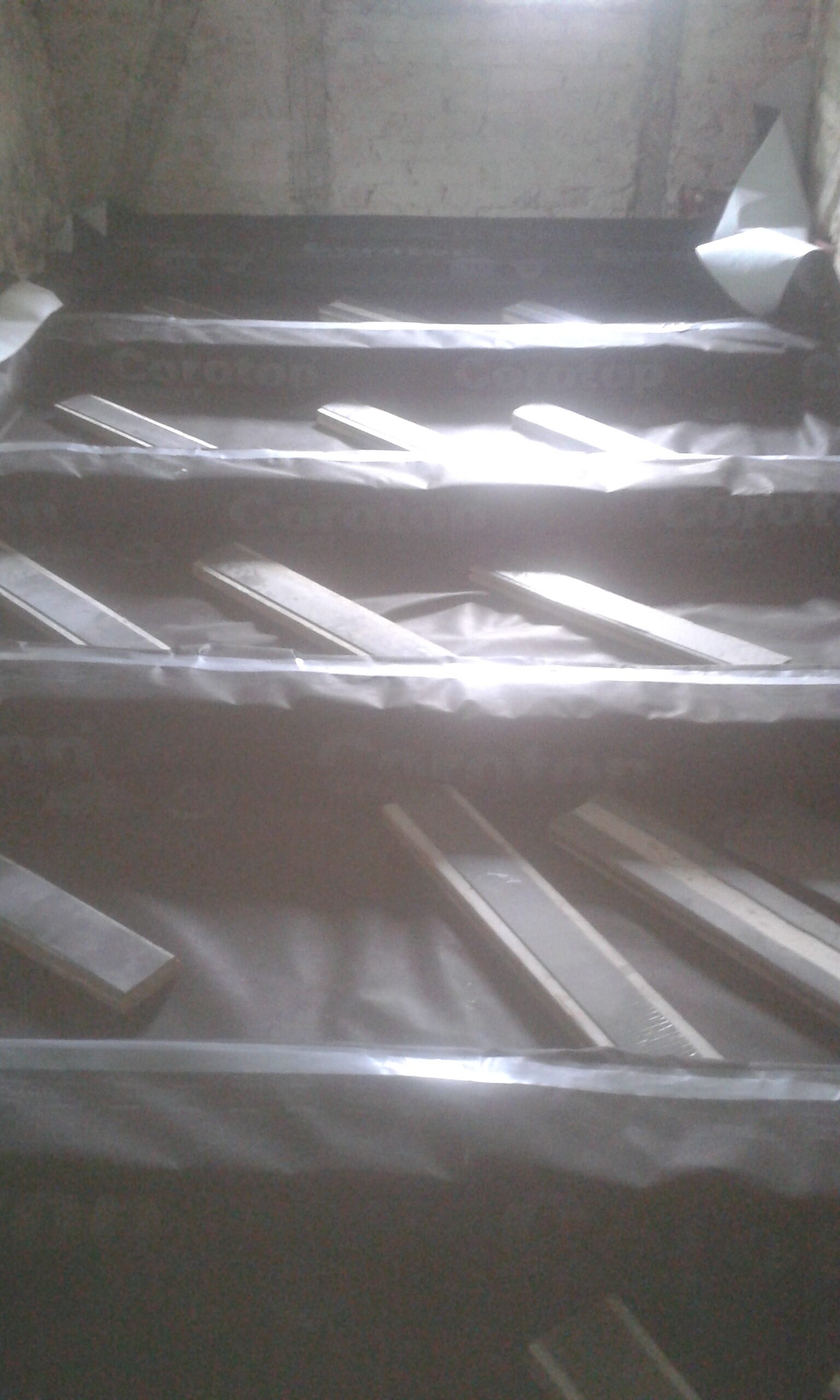 Strop poddasza z ułożoną paroizolacją i rozłożonymi listwami montażowymi, przygotowany do montażu płyt podłogowych.